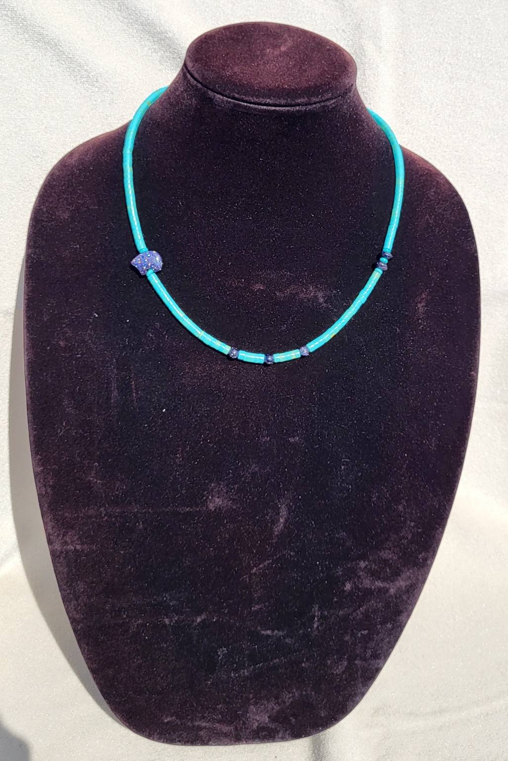 Turquoise tube bead necklace with a carved lapis bear and blue accents