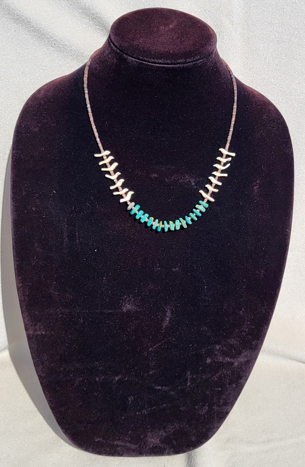 Necklace of white branch coral fringe with green turquoise nuggets at the centre