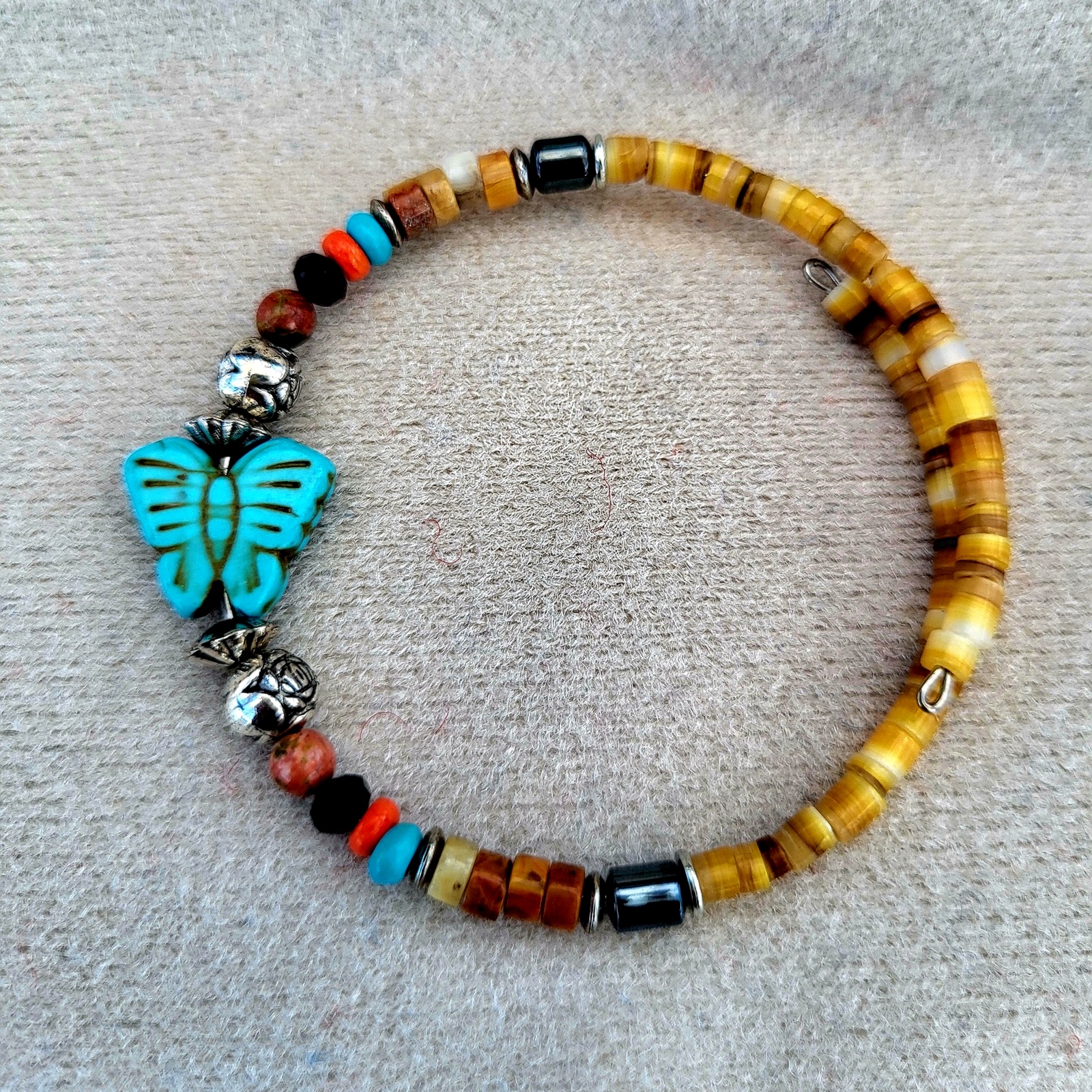 Golden shell heishi bracelet with a carved turquoise butterfly