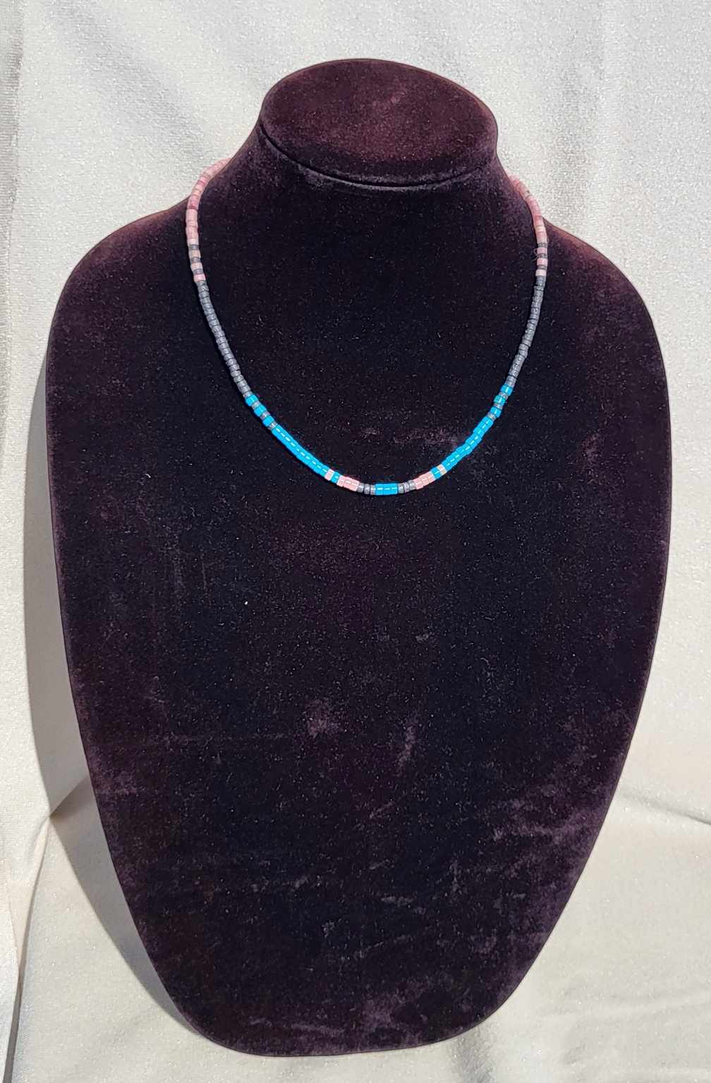 Strand necklace of blue turquoise heishi beads with pink and grey accents