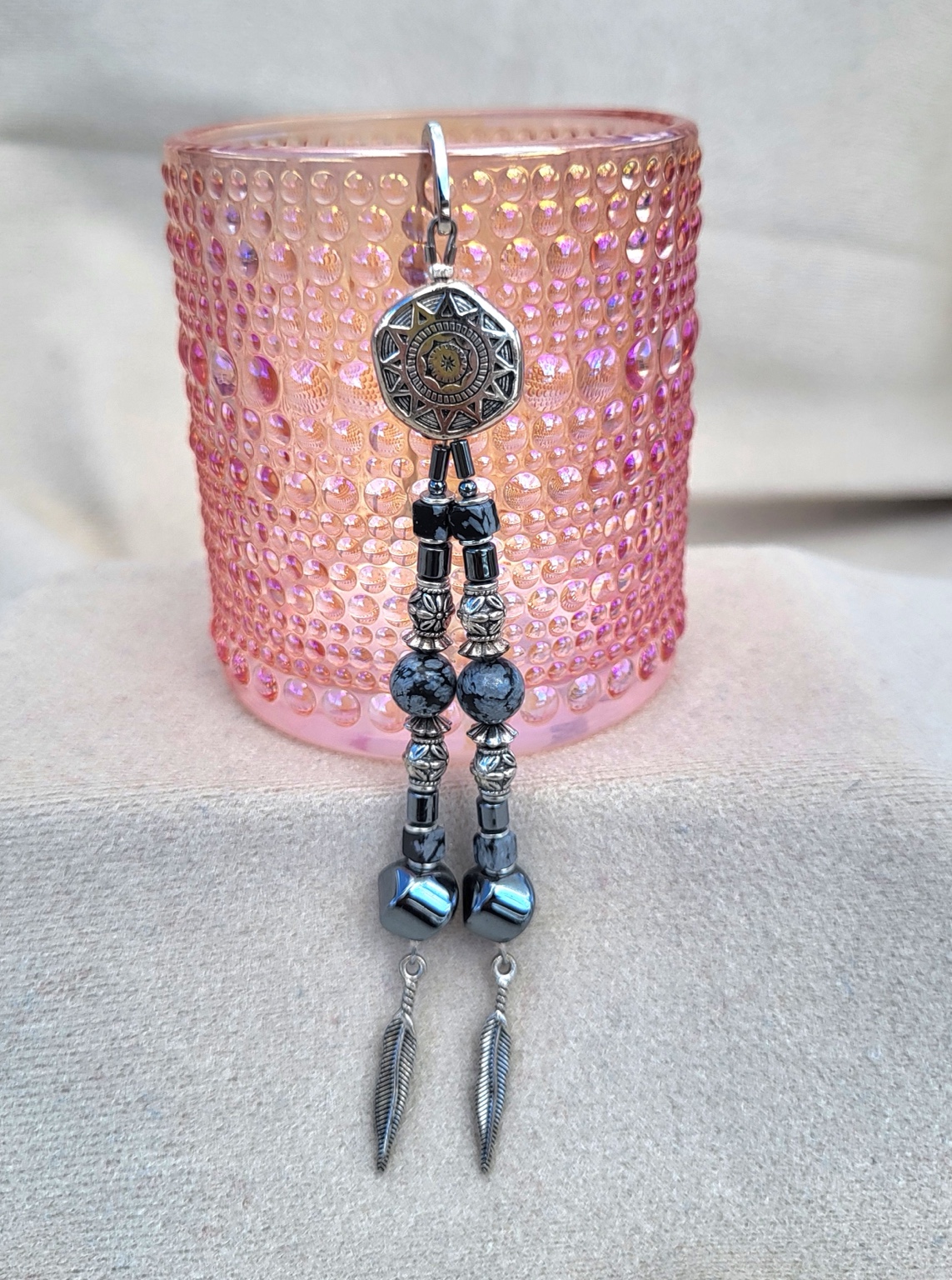 Long black and silver beaded earrings with stamped concho tops and feather charms