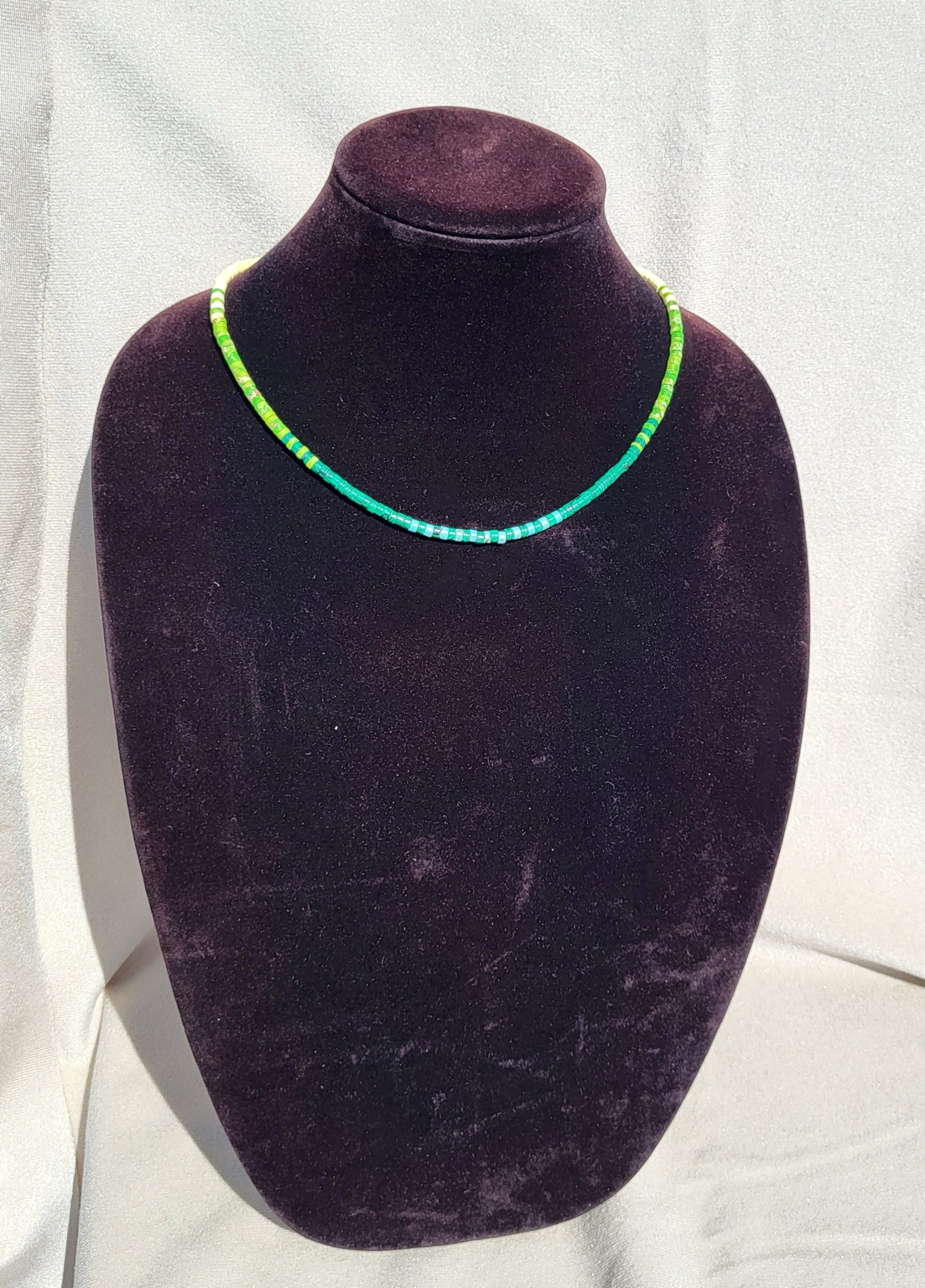 Strand necklace of green turquoise heishi beads with cream and lime accents